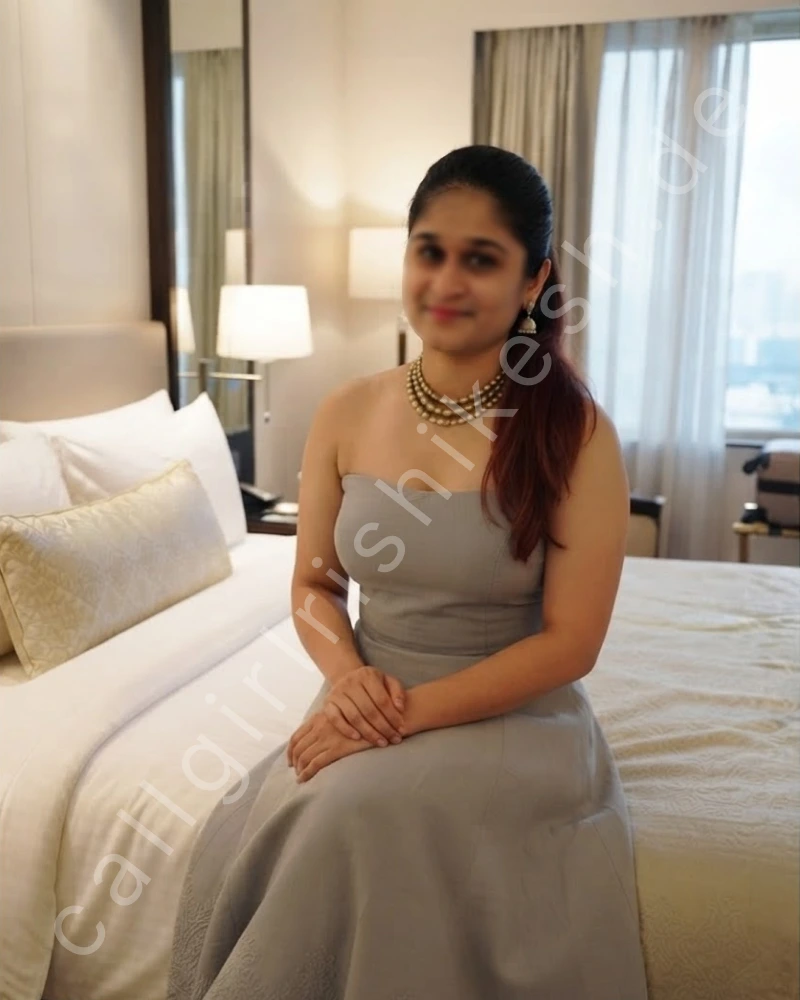 Independent call girl rishikesh wearing cream colour gown and sitting on bed