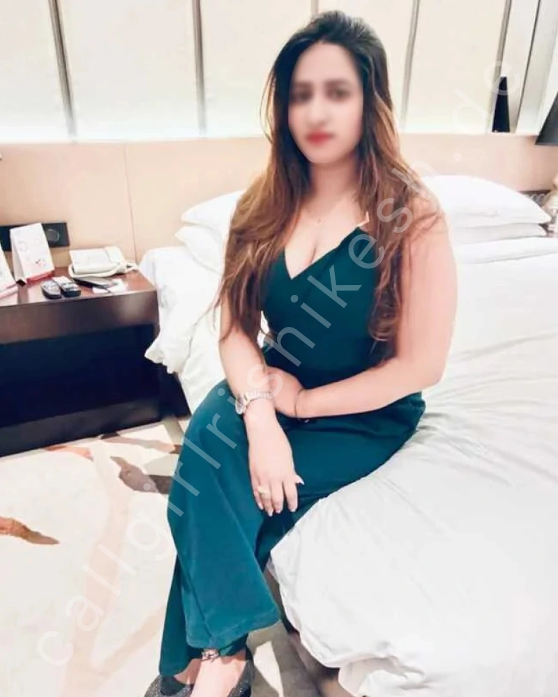 housewife call girl rishikesh wearing green dress sitting on bed